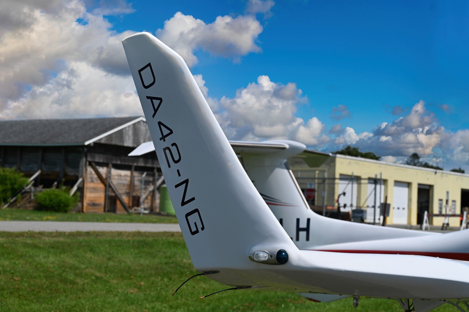 DA42NG tail fin against bright clouds