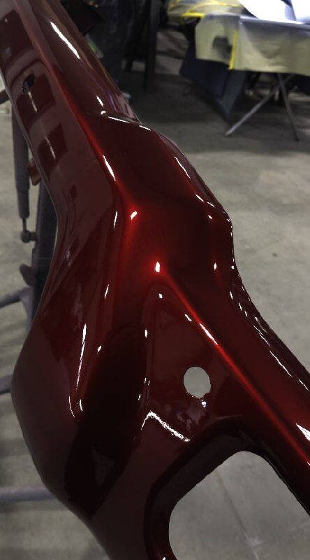 Close-up of a deep candy-red painted panel showing the gloss of the finish