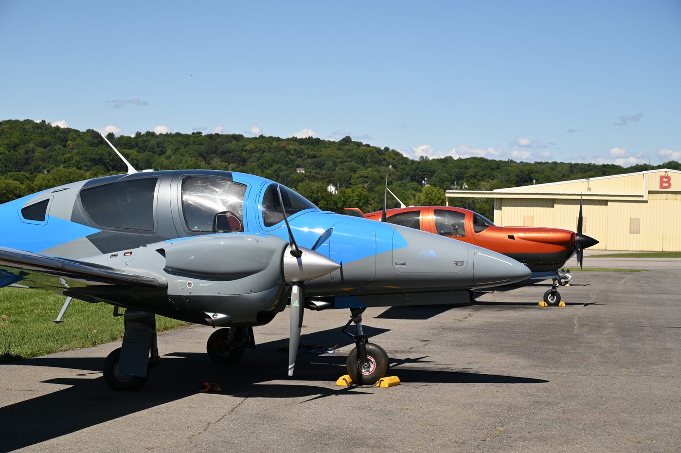 Two training aircraft parked nose-to-nose on the ramp